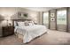 Comfortable main bedroom features soft carpeting, neutral walls, and natural light from two windows at 00123 Millstream Dr, China Grove, NC 28023