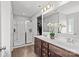 Bright bathroom featuring double sinks, hardwood floors, a glass shower, and elegant floral decor at 1062 River Haven Sw Ave, Concord, NC 28025