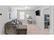 Cozy bedroom featuring a brown sectional sofa, a desk area, and a mounted television for entertainment at 1062 River Haven Sw Ave, Concord, NC 28025
