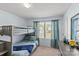 Cozy bedroom features a gray bunk bed, natural light, and a dark wood dresser at 1062 River Haven Sw Ave, Concord, NC 28025