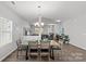 Bright dining area featuring a stylish table with modern seating, seamlessly connected to the kitchen and living room at 1062 River Haven Sw Ave, Concord, NC 28025