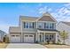 Charming two-story home with a two-car garage, gray siding, and a well-manicured lawn on a sunny day at 1062 River Haven Sw Ave, Concord, NC 28025