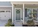 Welcoming front porch features gray siding, a charming wreath, and well-maintained landscaping, enhancing curb appeal at 1062 River Haven Sw Ave, Concord, NC 28025