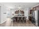 A modern kitchen featuring a center island with bar seating, granite countertops, and wood-look flooring at 1062 River Haven Sw Ave, Concord, NC 28025