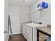 Functional laundry room with modern washer and dryer, ample storage, and sleek countertops for convenience at 1062 River Haven Sw Ave, Concord, NC 28025