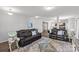 Bright living room showcasing comfortable seating, a glass coffee table, and stylish decor, ideal for entertaining at 1062 River Haven Sw Ave, Concord, NC 28025