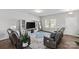 Cozy living room with a large TV, comfortable seating, and a stylish rug, perfect for relaxation and entertainment at 1062 River Haven Sw Ave, Concord, NC 28025