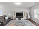 Comfortable living room featuring a modern entertainment center, cozy seating, and natural light, creating a relaxing space at 1062 River Haven Sw Ave, Concord, NC 28025