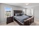 Comfortable main bedroom with a dark wood bed frame, matching dressers, and natural light at 1062 River Haven Sw Ave, Concord, NC 28025