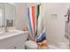 Bathroom features a white vanity and a shower tub combo with decorative curtain at 1104 Norris Ave, Charlotte, NC 28206