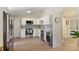 Bright and airy kitchen featuring white cabinets, stainless steel appliances, and wood look flooring at 1104 Norris Ave, Charlotte, NC 28206