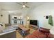 Bright living room with modern fan, sectional couch, hardwood floors, and connecting kitchen at 1104 Norris Ave, Charlotte, NC 28206