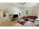 Bright living room with modern fan, sectional couch, hardwood floors, and connecting entry way at 1104 Norris Ave, Charlotte, NC 28206