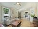 Bright living room with modern fan, sectional couch, hardwood floors, and connecting kitchen at 1104 Norris Ave, Charlotte, NC 28206