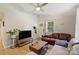 Bright living room with modern fan, sectional couch, hardwood floors, and connecting entry way at 1104 Norris Ave, Charlotte, NC 28206