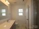 Clean bathroom with a large mirror, single sink vanity, and glass-enclosed shower at 1119 Overbrook Pl, Wingate, NC 28174