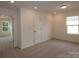 Bright bedroom with carpet flooring, natural light from windows, and multiple doorways at 1119 Overbrook Pl, Wingate, NC 28174