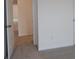 Neutral hallway shows carpeted floors, white walls and trim and natural light coming from end of hallway at 1119 Overbrook Pl, Wingate, NC 28174