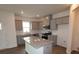 Well-lit kitchen features gray cabinetry, granite countertops, stainless steel appliances, and a central island at 1119 Overbrook Pl, Wingate, NC 28174