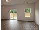 Bright living room with wood floors, natural light from windows and sliding glass doors to outdoor space at 1119 Overbrook Pl, Wingate, NC 28174