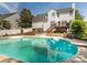 Private backyard oasis featuring a sparkling pool, spacious deck, and lush landscaping for outdoor enjoyment at 113 Rocky Trail Ct, Fort Mill, SC 29715