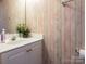 Cozy bathroom features a white vanity, sink, flower accents, and wallpaper at 113 Rocky Trail Ct, Fort Mill, SC 29715