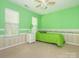 A well-lit bedroom with a ceiling fan and striped wallpaper border, providing a fresh and airy feel at 113 Rocky Trail Ct, Fort Mill, SC 29715