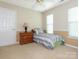 A simple bedroom with a single bed, natural light, and a classic nightstand, offering a comfortable retreat at 113 Rocky Trail Ct, Fort Mill, SC 29715