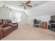 A versatile bonus room with comfortable seating and a dedicated workspace, blending relaxation with productivity at 113 Rocky Trail Ct, Fort Mill, SC 29715