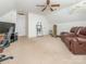 An open bonus room featuring a leather sofa, gym equipment, and ample space, perfect for recreation or relaxation at 113 Rocky Trail Ct, Fort Mill, SC 29715