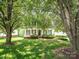 Charming two-story home with a inviting front porch, lush lawn and mature trees at 113 Rocky Trail Ct, Fort Mill, SC 29715