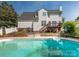Exterior shot of pool and deck with a two-story home in background at 113 Rocky Trail Ct, Fort Mill, SC 29715