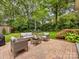 Inviting back patio with comfortable seating and a well-maintained garden at 1209 Yale Pl, Charlotte, NC 28209