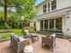 Cozy back patio with outdoor seating, lush plants, and access to the house at 1209 Yale Pl, Charlotte, NC 28209