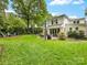 Expansive backyard featuring a lush lawn, patio, and mature trees at 1209 Yale Pl, Charlotte, NC 28209