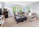 Finished basement featuring a large sectional sofa, accent chairs and neutral carpet at 1209 Yale Pl, Charlotte, NC 28209