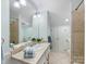 Bathroom with a tile floor, neutral walls, double vanity and large mirror at 1209 Yale Pl, Charlotte, NC 28209