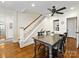 Dining area with hardwood floors, a staircase, and natural lighting from a nearby window at 1209 Yale Pl, Charlotte, NC 28209