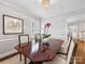 Formal dining area featuring a dark wood table, chandelier lighting and a view to the living area at 1209 Yale Pl, Charlotte, NC 28209