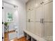 Entryway with built-in storage lockers, hardwood floors, and an adjacent powder room at 1209 Yale Pl, Charlotte, NC 28209