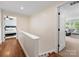 Upstairs hallway featuring hardwood floors and access to multiple rooms with neutral paint at 1209 Yale Pl, Charlotte, NC 28209