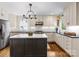 Modern kitchen with island, stainless steel appliances, white subway tile backsplash, and hardwood floors at 1209 Yale Pl, Charlotte, NC 28209