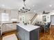 Open kitchen with a central island, hardwood floors, dining area and staircase at 1209 Yale Pl, Charlotte, NC 28209