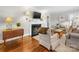 Cozy living room featuring a fireplace, hardwood floors, and comfortable seating arrangement at 1209 Yale Pl, Charlotte, NC 28209