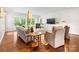 Bright living room boasts hardwood floors, neutral tones, large windows, and comfortable seating arrangements at 1209 Yale Pl, Charlotte, NC 28209