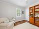 Cozy office space with hardwood floors, natural light, comfortable seating, and a functional bookcase at 1209 Yale Pl, Charlotte, NC 28209