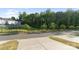 View of the backyard of a community with trees and a black fence at 131 Berkeley Ave # D, Mooresville, NC 28117