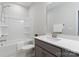 Well-lit bathroom featuring a bathtub, shower, and vanity with a quartz countertop at 131 Berkeley Ave # D, Mooresville, NC 28117