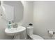 Bathroom with a pedestal sink, modern mirror and standard toilet at 131 Berkeley Ave # D, Mooresville, NC 28117