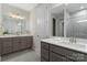 Stylish bathroom boasts dual sinks, quartz countertops, modern lighting, and a tiled shower with a glass door at 131 Berkeley Ave # D, Mooresville, NC 28117
